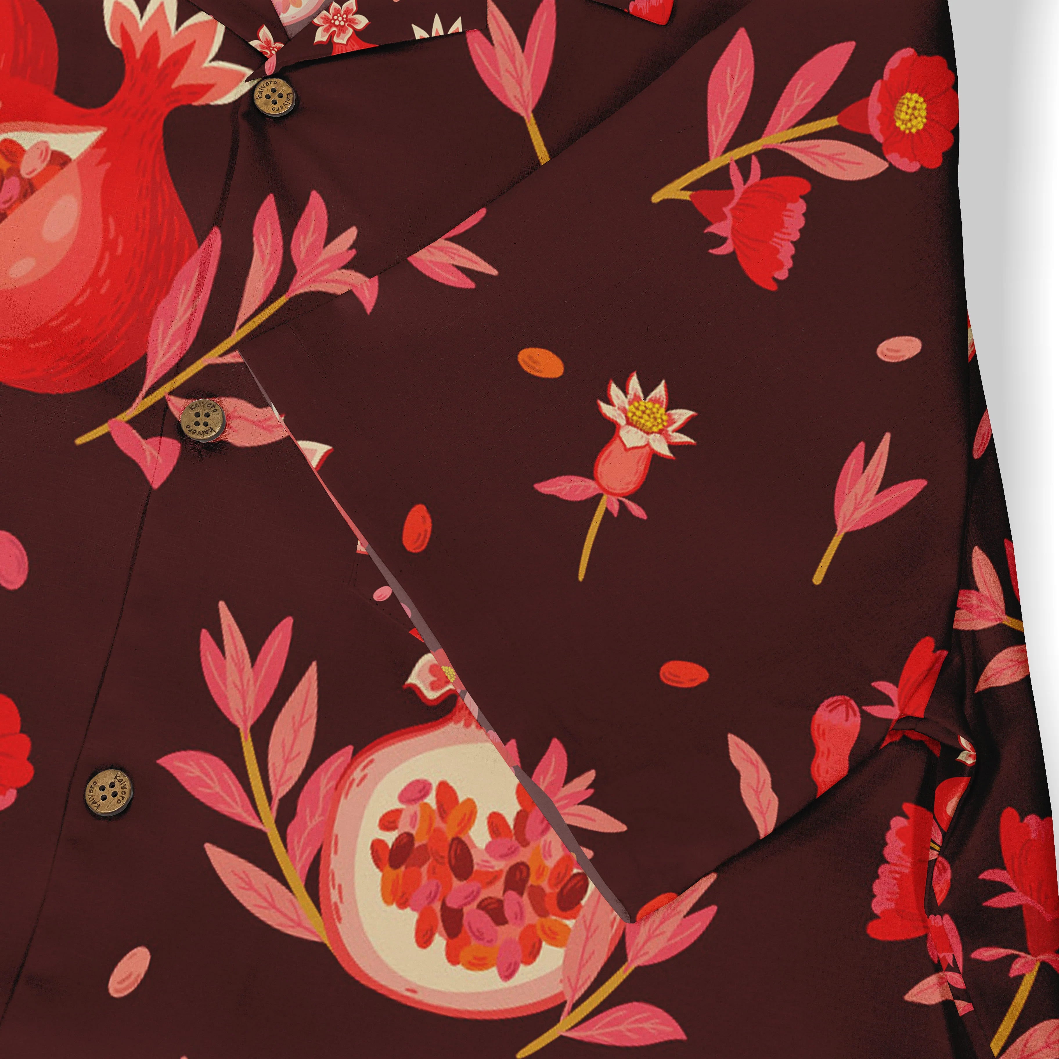 Red floral shirt with pomegranate design, buttons visible.
