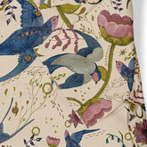 Floral and bird patterned fabric with blue birds, pink flowers.