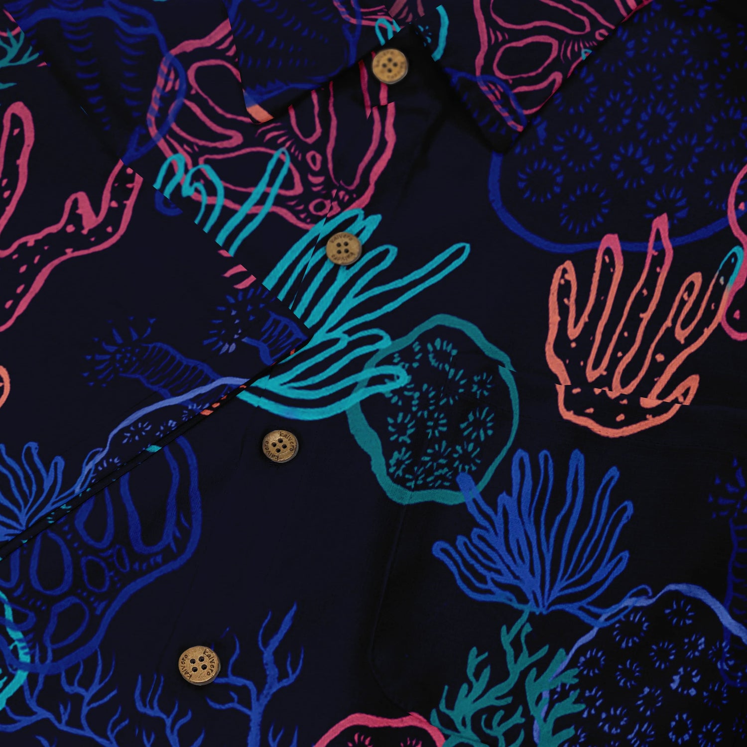 Vibrant coral-patterned shirt with bold colors and wooden buttons.