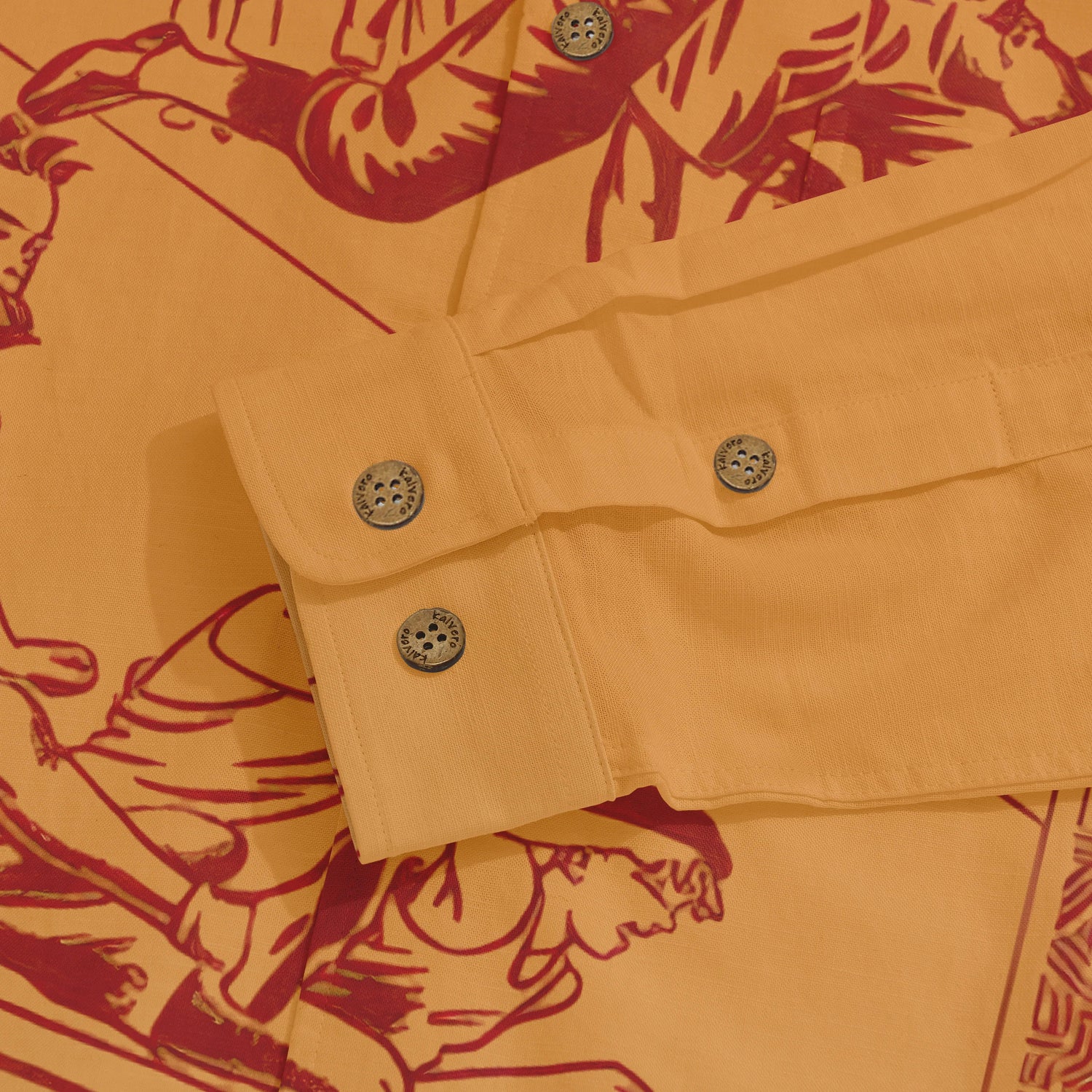 Orange shirt with red graphic print, featuring buttoned cuffs.