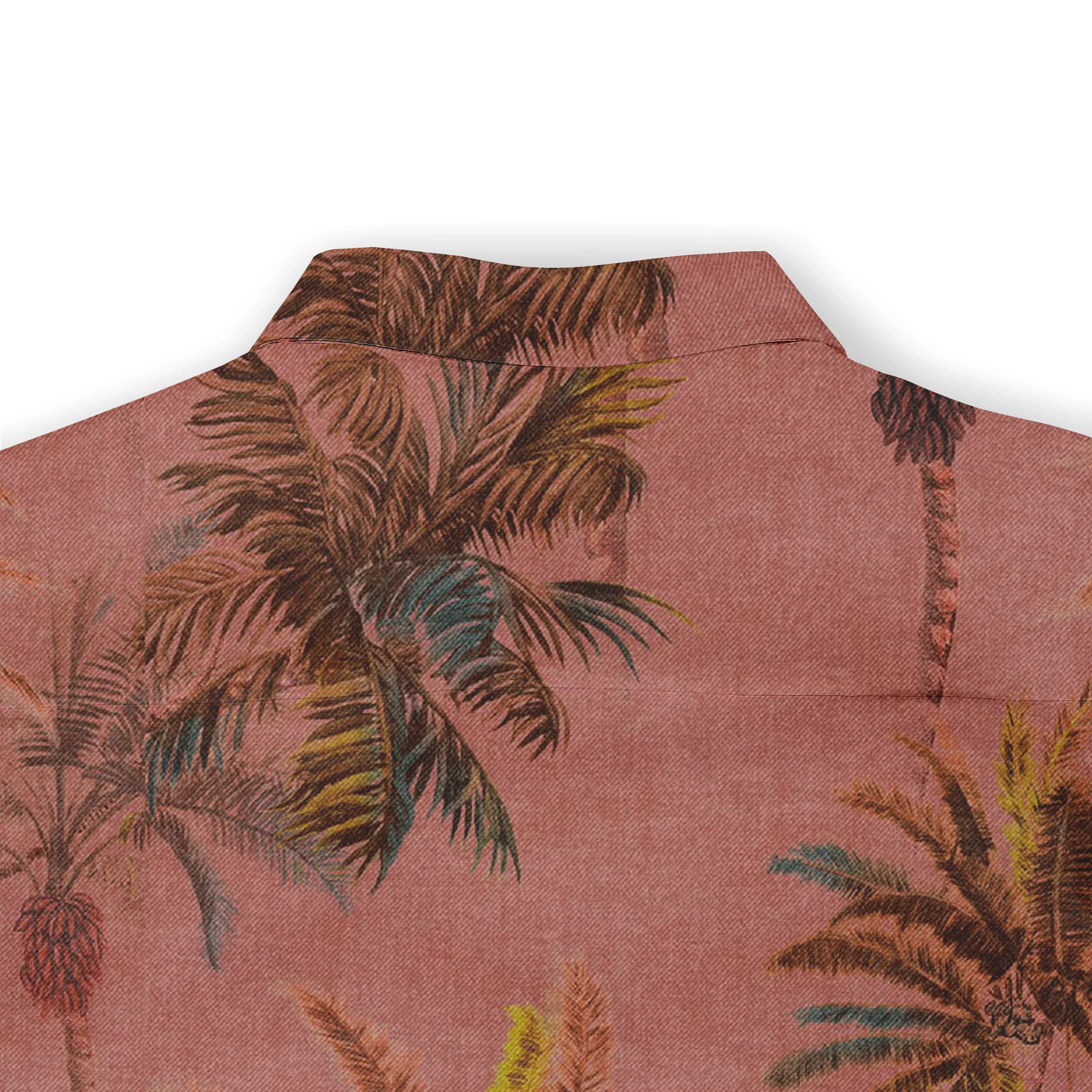 Pink shirt with tropical palm print, featuring a collar and vibrant.
