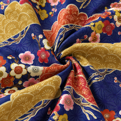 KALVERO Japanese Skyscape: fabric detail showing ochre and rust Japanese pines with plum blossoms over an indigo geometric lattice.