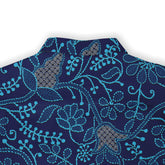 Navy blue fabric with intricate turquoise floral embroidery.
