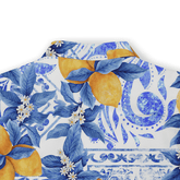 Blue and white floral pattern with lemons and leaves on a shirt.