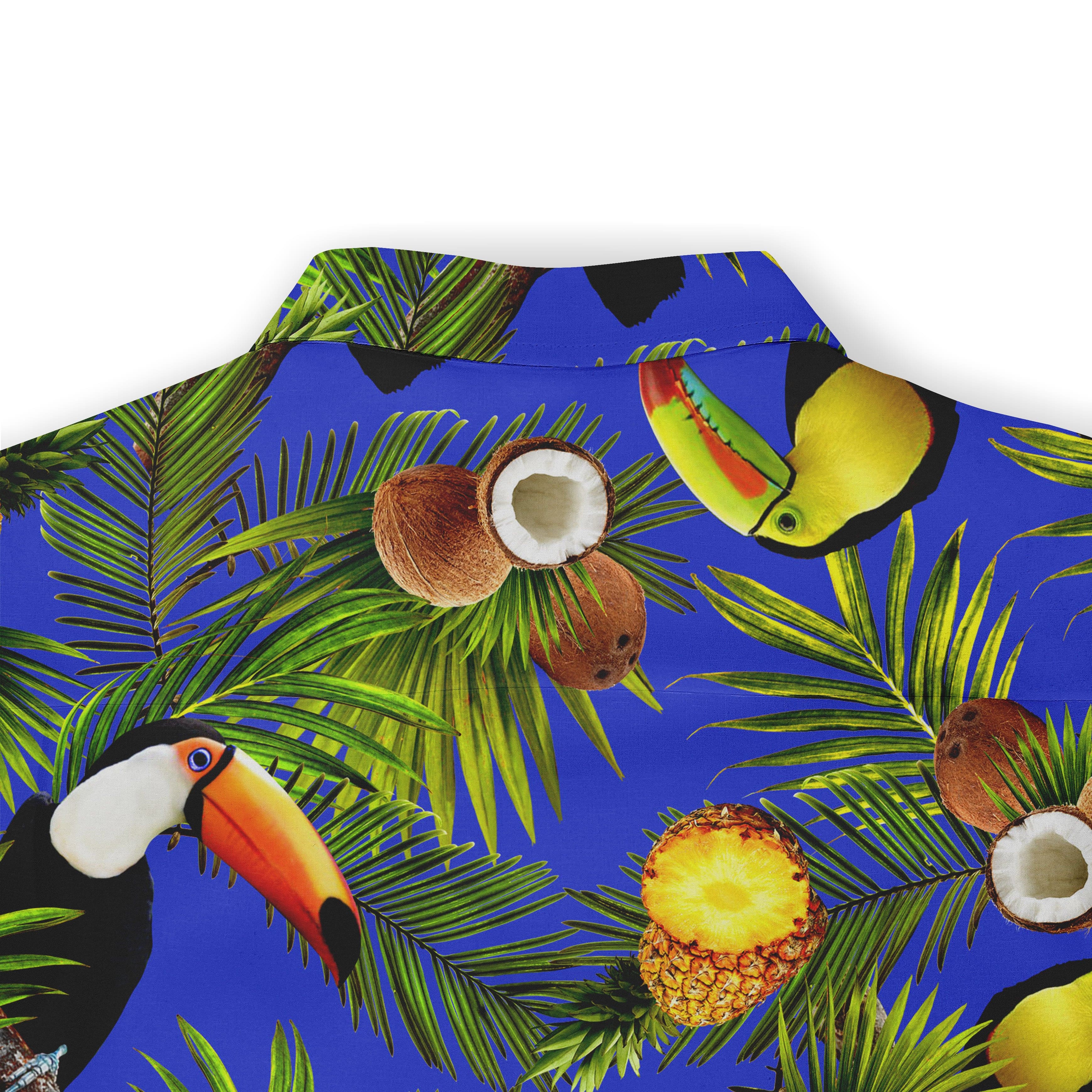 Blue shirt with toucans, coconuts, pineapple, and palm leaves.