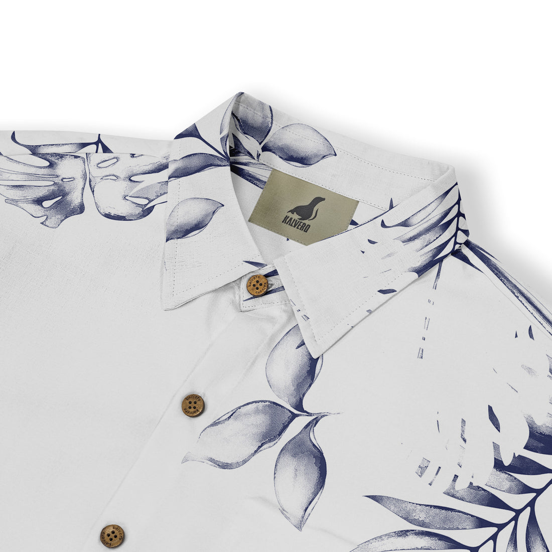 White shirt with blue leaf print, wooden buttons, and Kalvero brand.