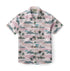 Pink shirt with palm trees and mountains pattern.
