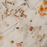 Cream shirt with floral print and wooden buttons, featuring.
