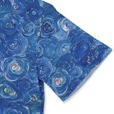 Blue floral patterned fabric with rose designs in various shades of.