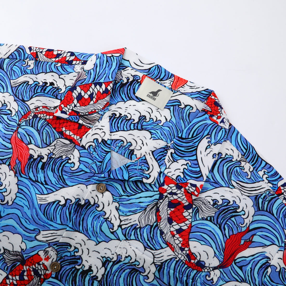 Blue wave pattern shirt with red fish, white collar tag.