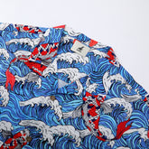 Blue wave pattern shirt with red fish, white collar tag.