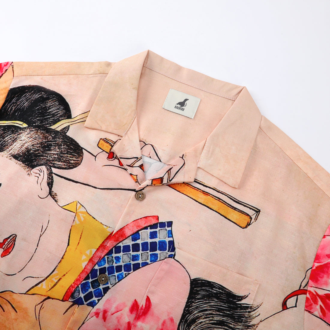 Pink shirt with Japanese art print, buttons, and collar tag.