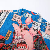 Blue shirt with pink demon design, Japanese text, and waves.
