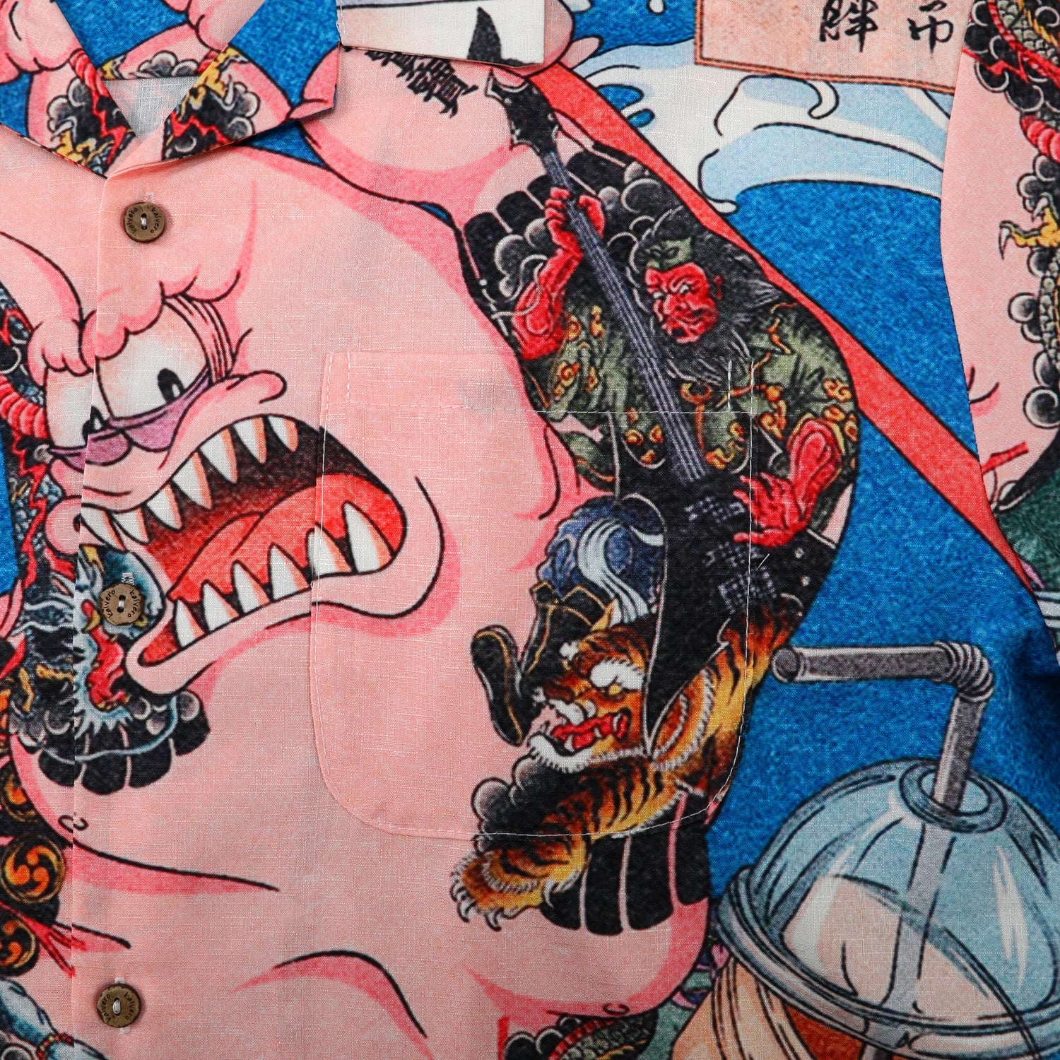 Colorful shirt with cartoon and traditional art designs.
