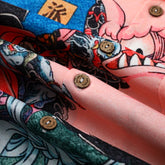 Colorful tattoo-style fabric with buttons, folded.