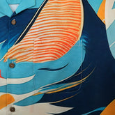 Blue shirt with orange-striped fish design.
