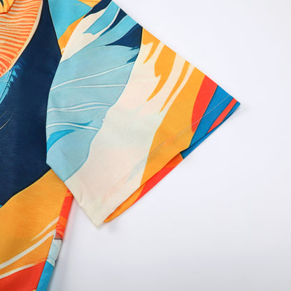 Colorful fabric with blue, orange, and white leaf patterns.