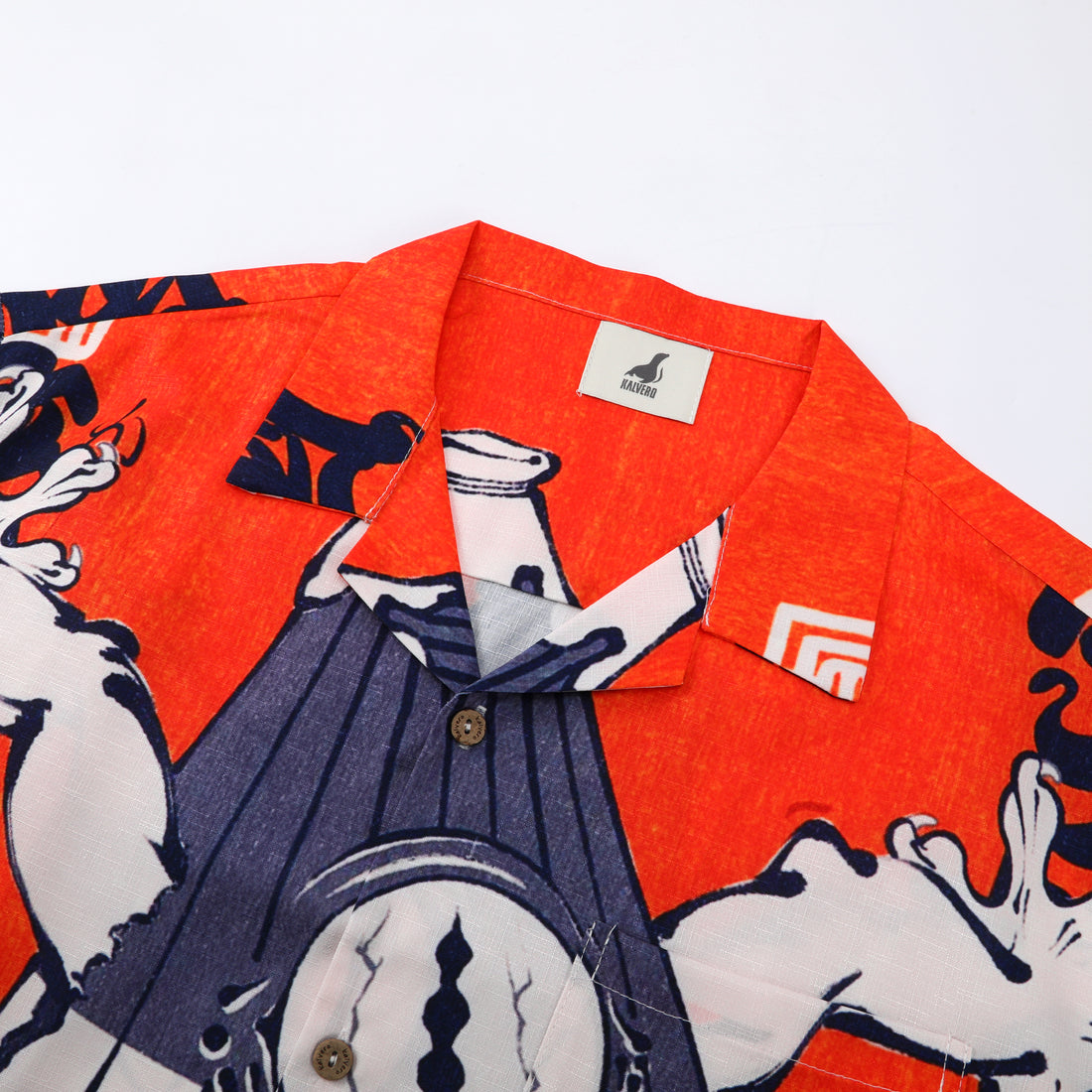 Orange shirt with blue and white graphic design, buttoned.