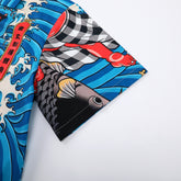 Colorful shirt with fish and waves design, blue background.