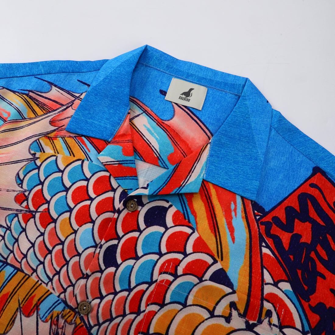 Blue collar shirt with colorful fish scale pattern.