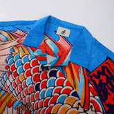 Blue collar shirt with colorful fish scale pattern.