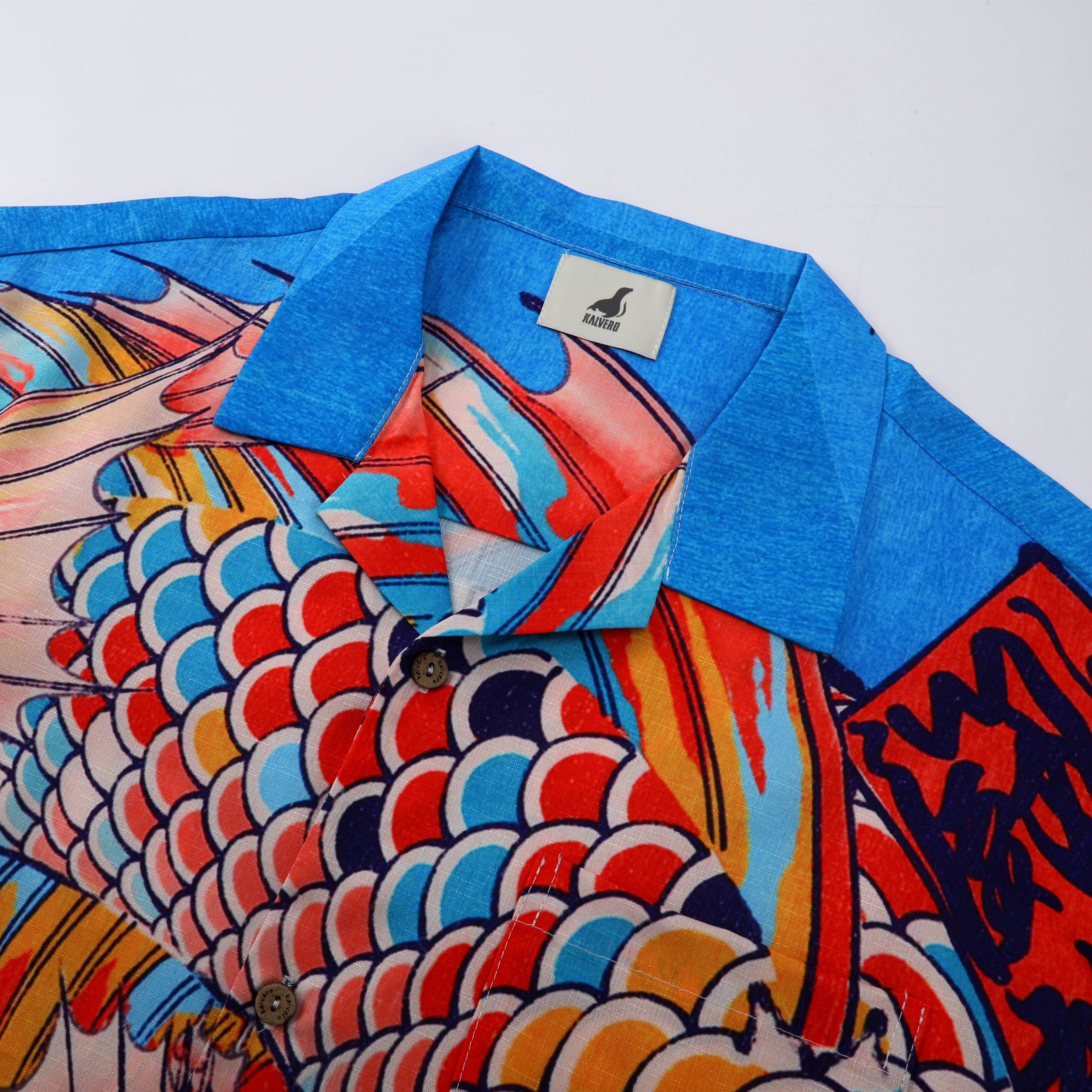 Blue collar shirt with colorful fish scale pattern.