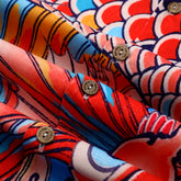 Colorful patterned fabric with buttons, folded.