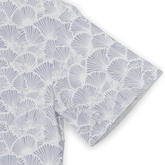 Light blue and white fabric with a repeating shell pattern, folded.