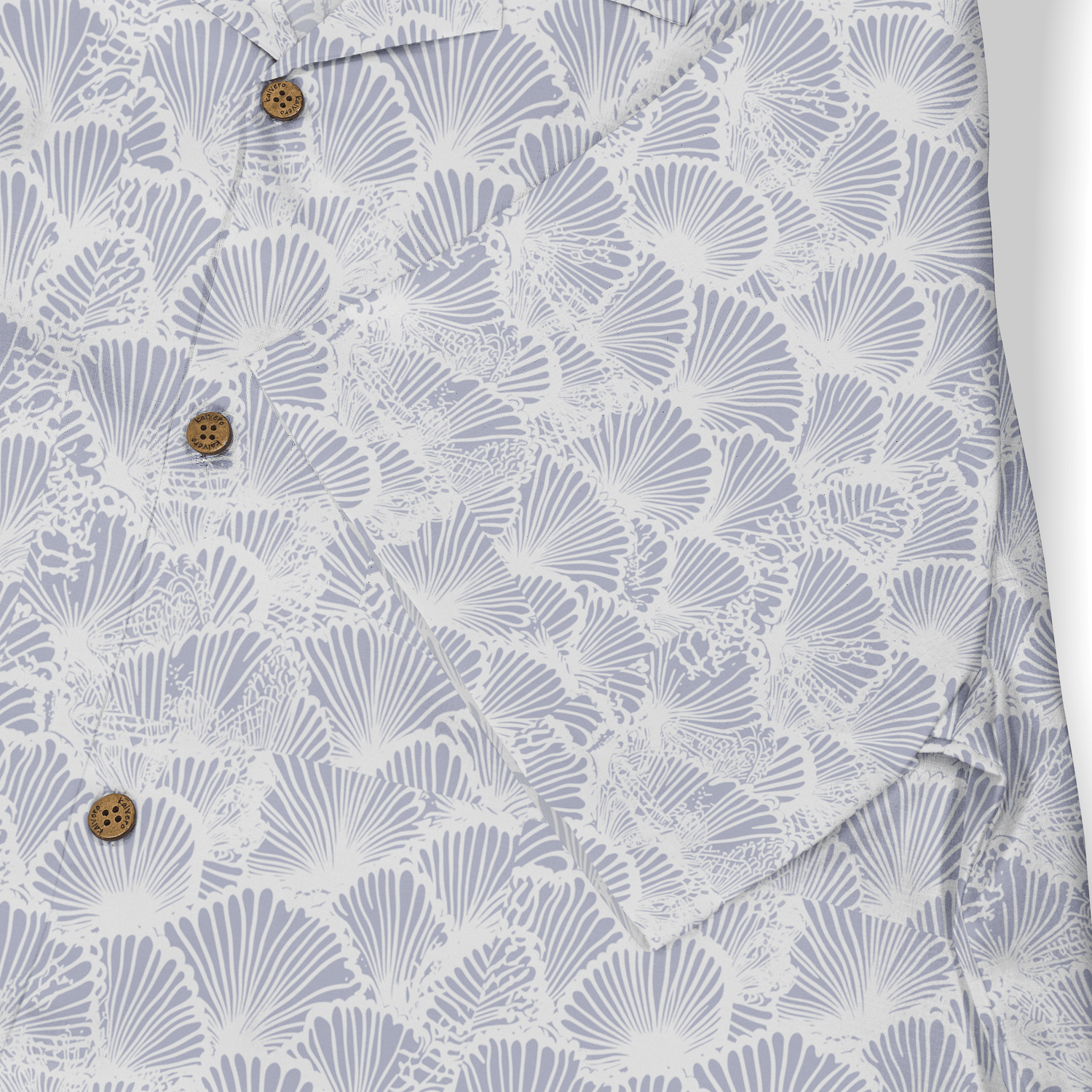 Light blue shirt with white fan patterns and brown buttons.