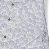 Light blue shirt with white fan patterns and brown buttons.