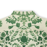 Green floral pattern on cream fabric, folded neatly.