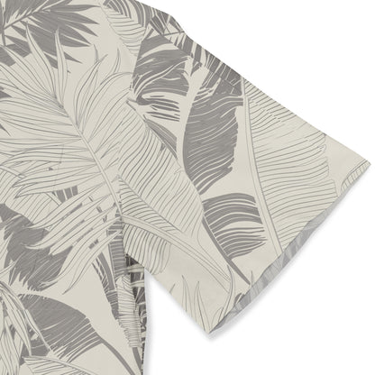 Gray and beige tropical leaf patterned fabric, folded neatly.