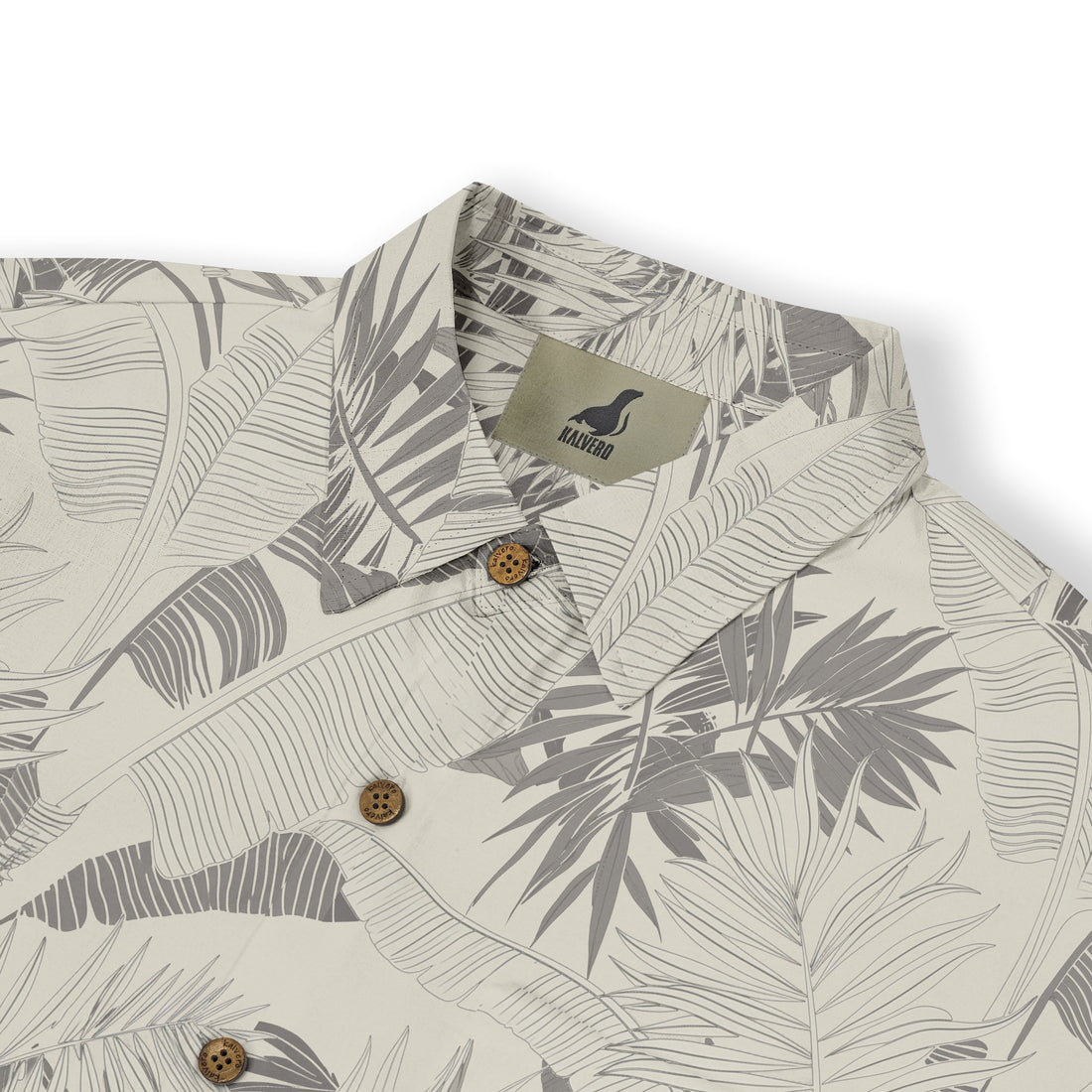 Beige shirt with gray leaf pattern, wooden buttons, and brand tag.