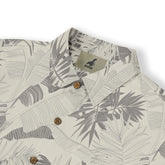 Beige shirt with gray leaf pattern, wooden buttons, and brand tag.