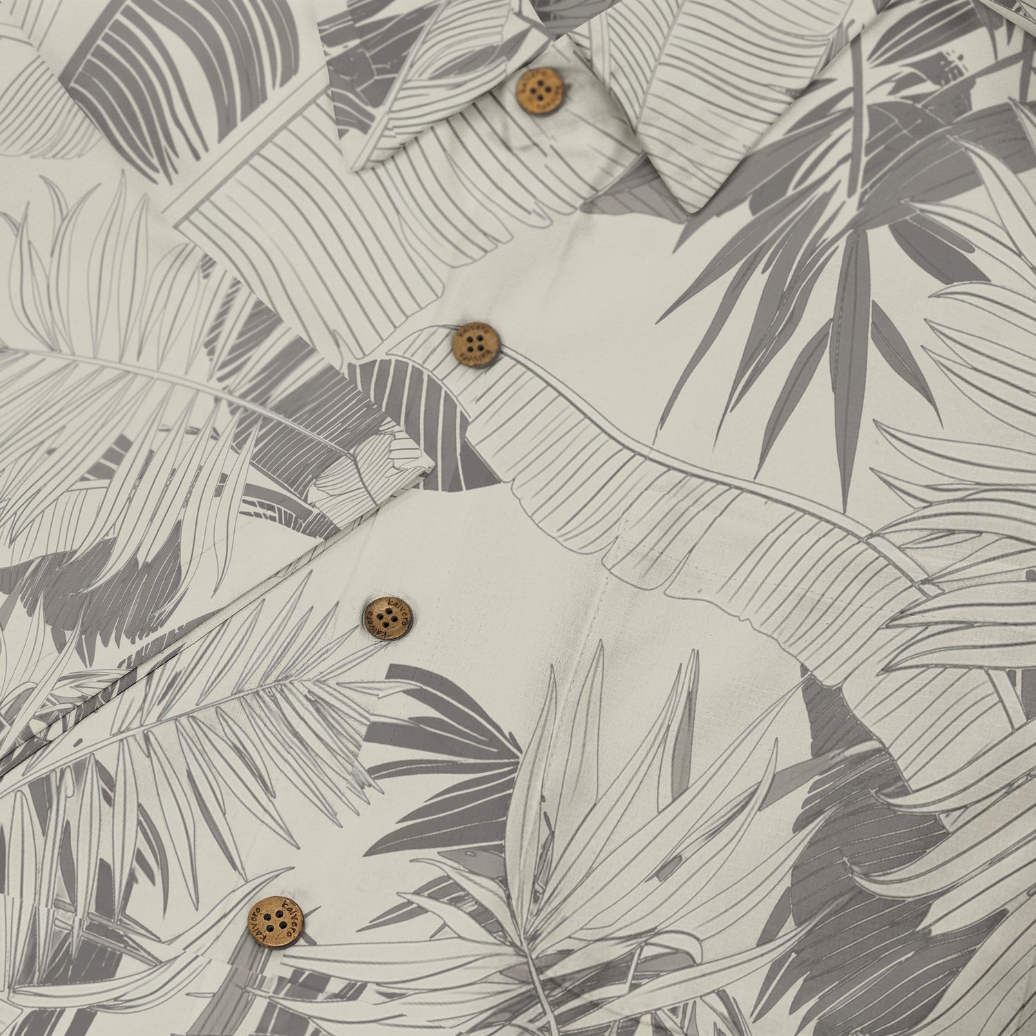 Gray and white tropical leaf pattern shirt with wooden buttons.