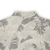 Beige shirt with gray tropical leaf pattern.