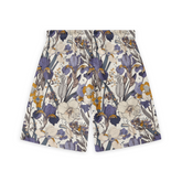 A pair of shorts featuring a design with intricate purple and yellow flowers with leaves on a light background, creating a detailed and elegant floral pattern.