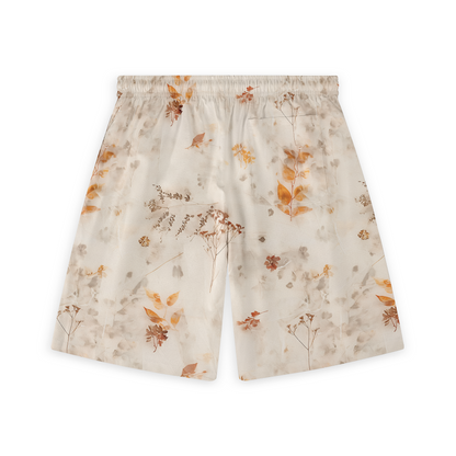 A pair of shorts featuring a soft, delicate design with subtle autumn leaves and botanical elements in warm, earthy tones on a light background, creating a gentle and serene look.