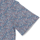 A classic paisley shirt with intricate floral details in blue, red, and green, dyed with natural indigo and madder root sleeve close-up