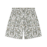 A pair of shorts featuring a design with intricate paisley patterns in soft shades of green, beige, and gold on a white background, creating a classic and elegant look.