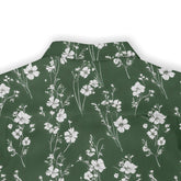 Green shirt with white floral print.