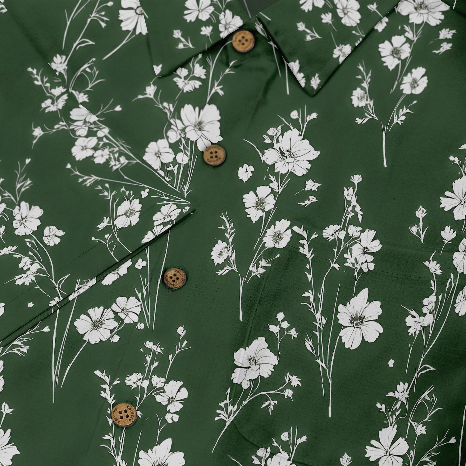 Green shirt with white floral print and wooden buttons.