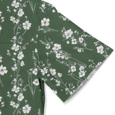 Green T-shirt with white floral print, folded neatly.