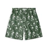 Green short with white floral pattern, showcasing delicate blossoms in a serene design.