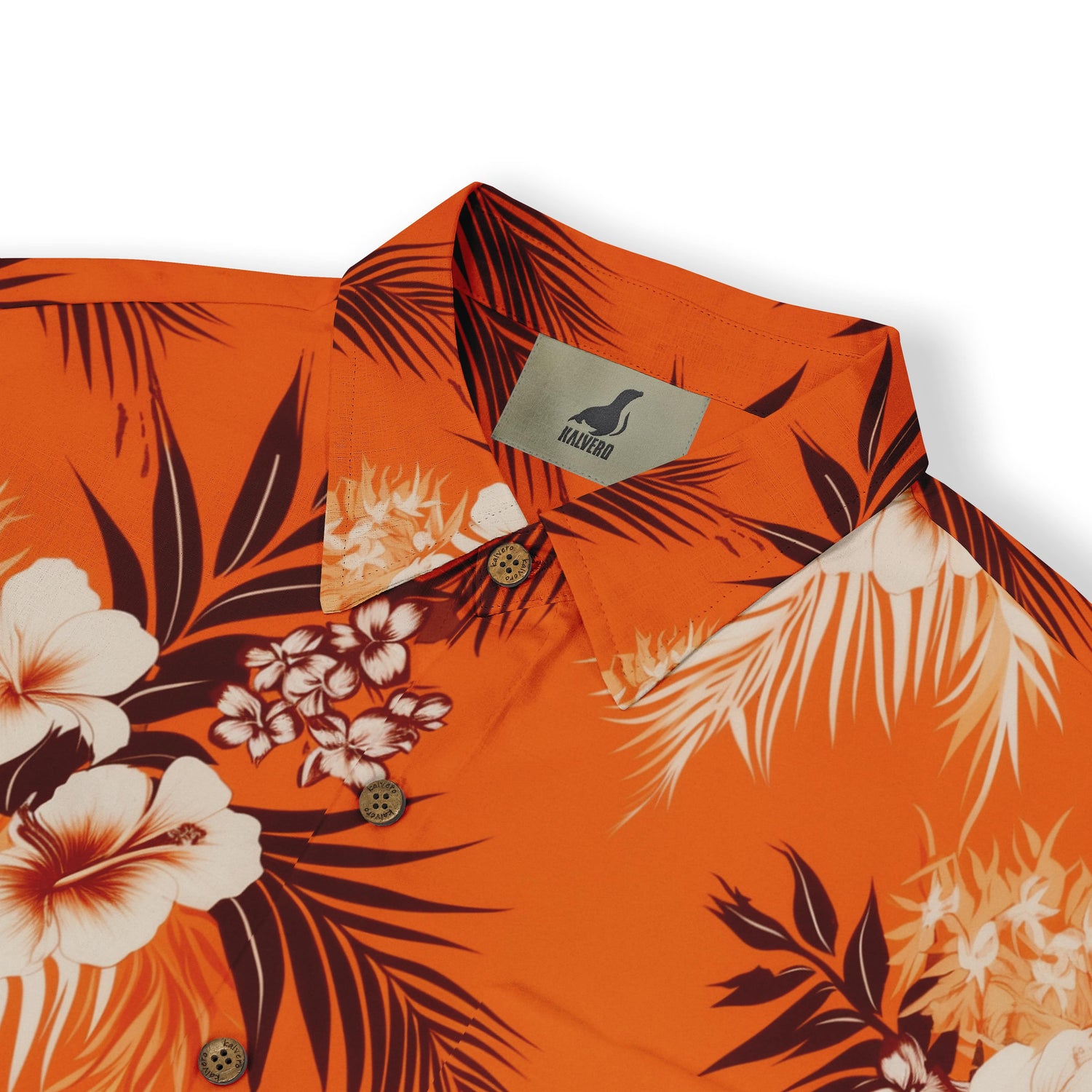 Close-up of tropical floral pattern on an orange shirt.