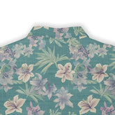 Elegant shirt with intricate flowers and leaves in soft colors.