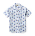 Light blue shirt with palm tree print and chest pocket.