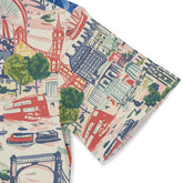 Colorful cityscape fabric with landmarks and vehicles.