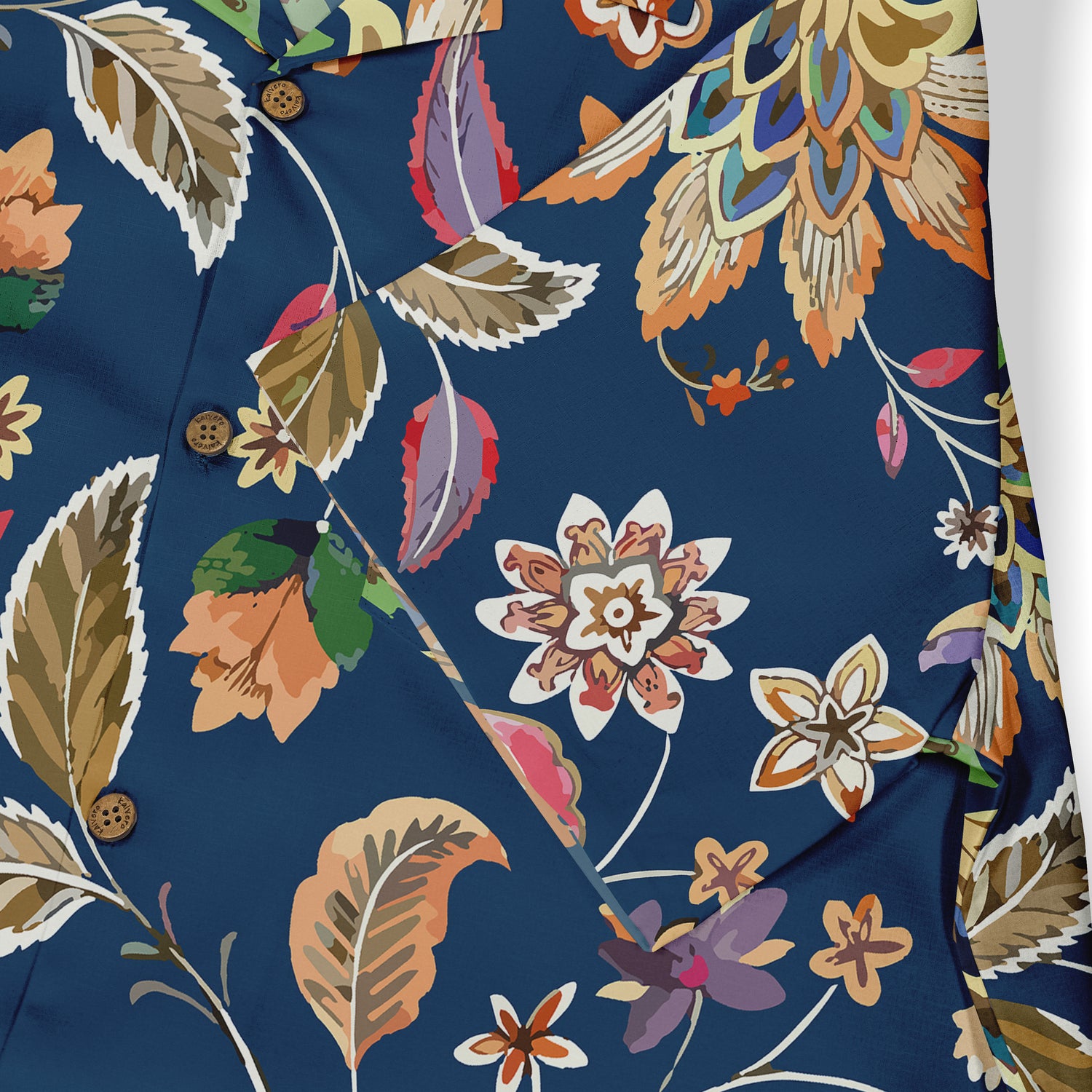 Close-up of a shirt featuring a colorful floral design with leaves and intricate patterns on a deep blue background.