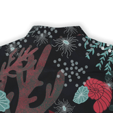 Black shirt with vibrant red coral, teal leaves, and white jellyfish.